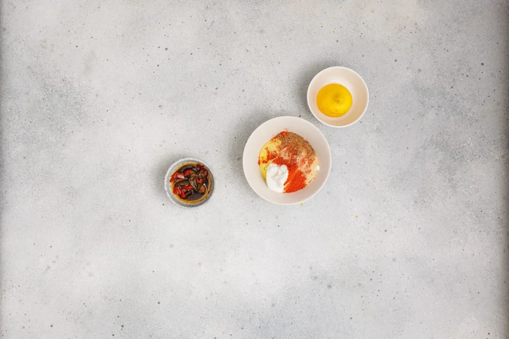 Ingredients for chipotle ranch dressing combined in a bowl before mixing.
