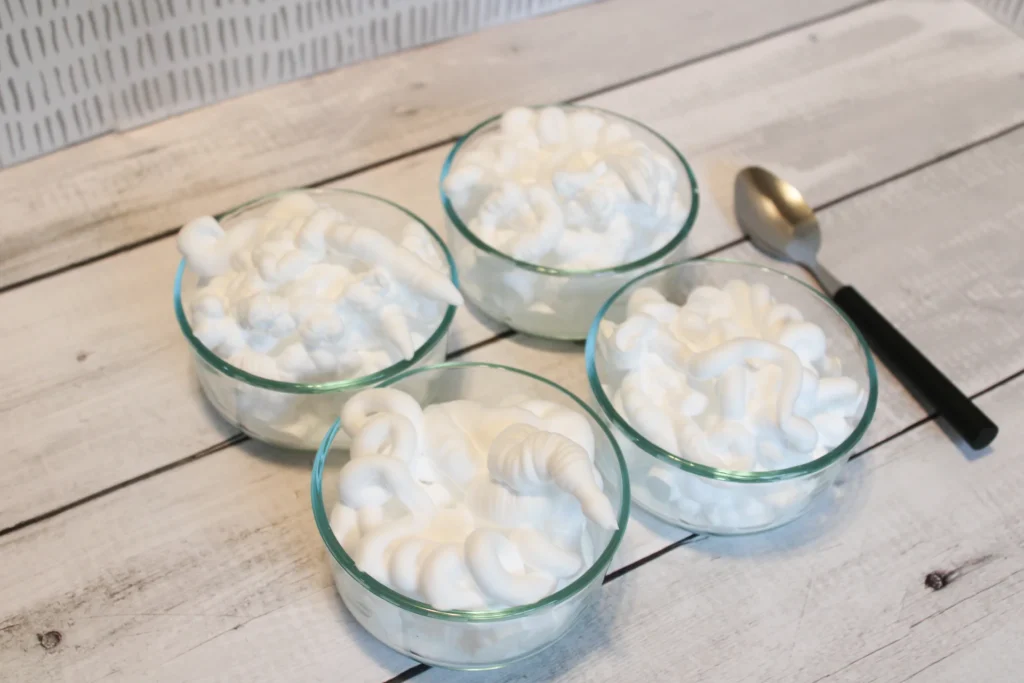 Shaving cream added to bowls of glue, ready to be mixed for puffy paint.