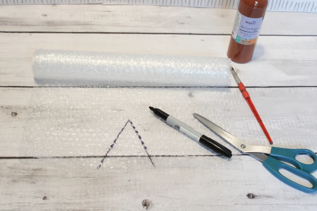 A triangle shape traced on bubble wrap with a black Sharpie for the ice cream cone.