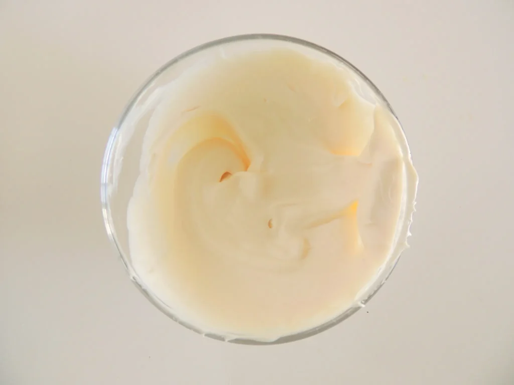 Bowl of smooth melted white chocolate ready for dipping.