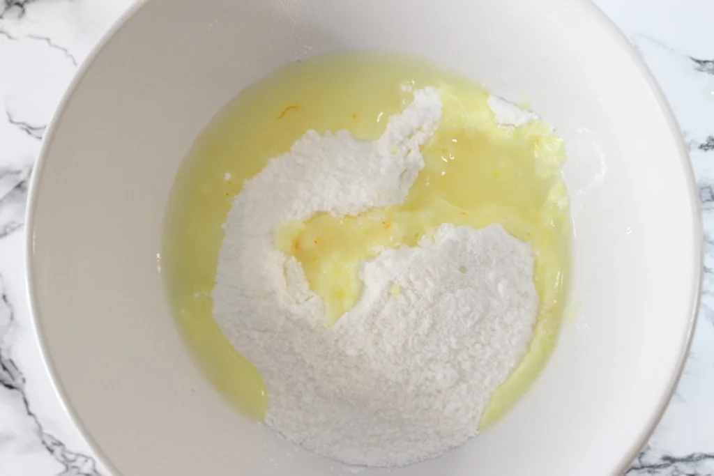 Liquid added to dry pudding mixture in a white bowl