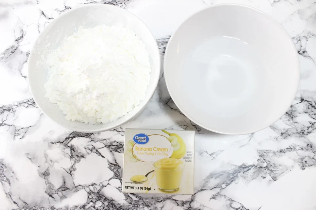 Ingredients for making pudding play dough using the second method laid out on a marble surface