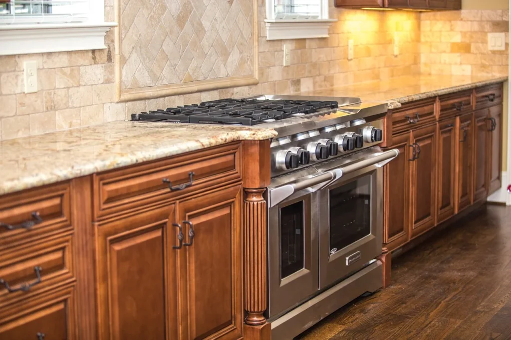 Close-up of wood kitchen cabinets and stove highlighting smooth, polished wood surfaces that resist dulling.