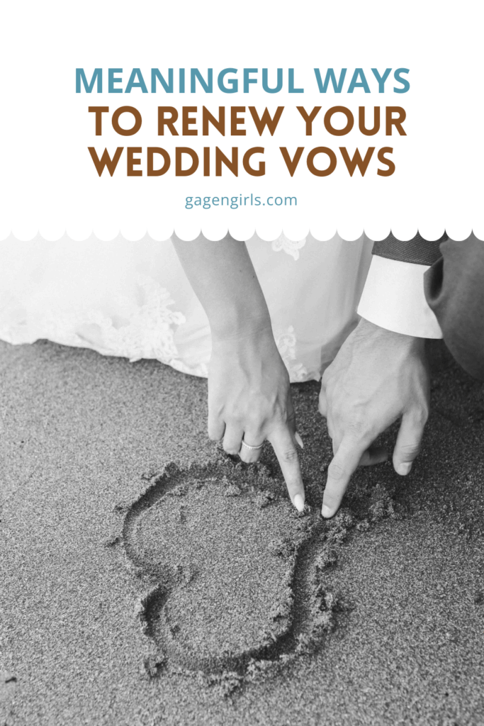 couple drawing heart in sand together during vow renewal moment