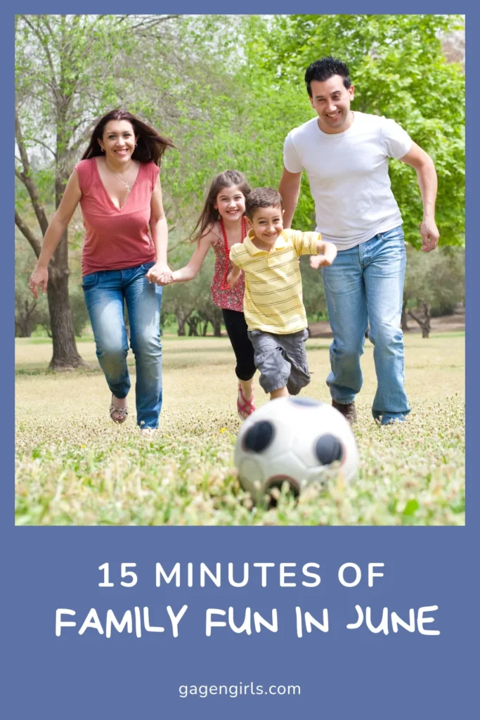 Family running and playing soccer together outside on a sunny summer day.