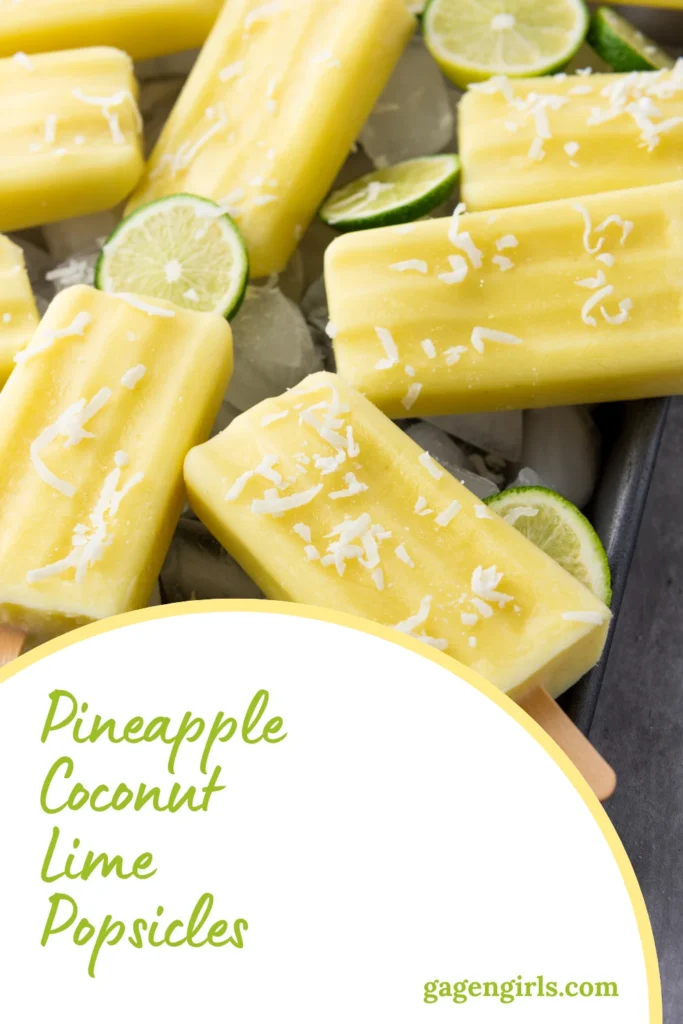 Close-up of homemade pineapple coconut lime popsicles garnished with shredded coconut and lime slices.