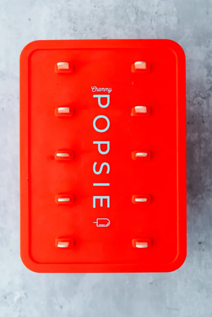 Filled popsicle mold with sticks inserted and ready to freeze.