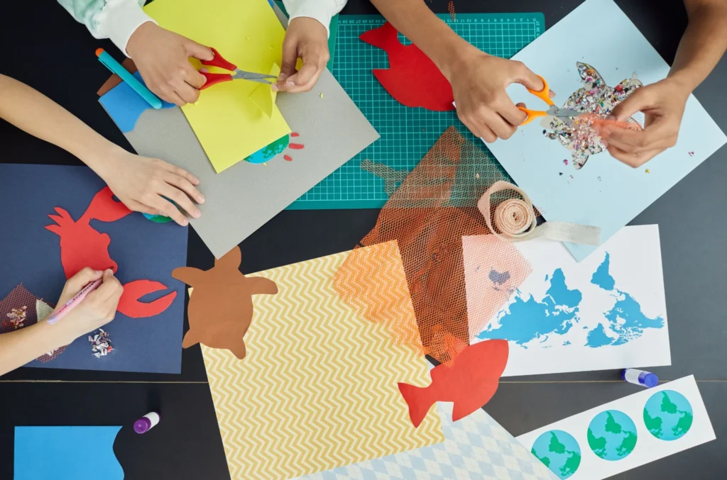 Children making colorful paper crafts as an indoor rainy day activity.