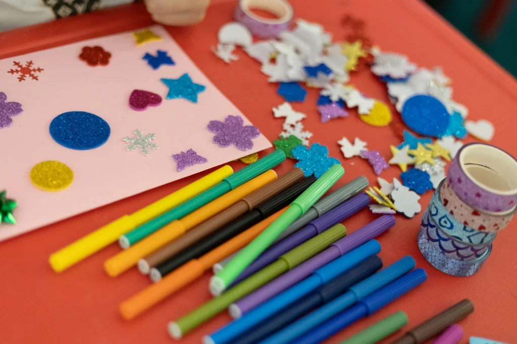 Markers, foam stickers, and craft supplies for creative rainy day activities.