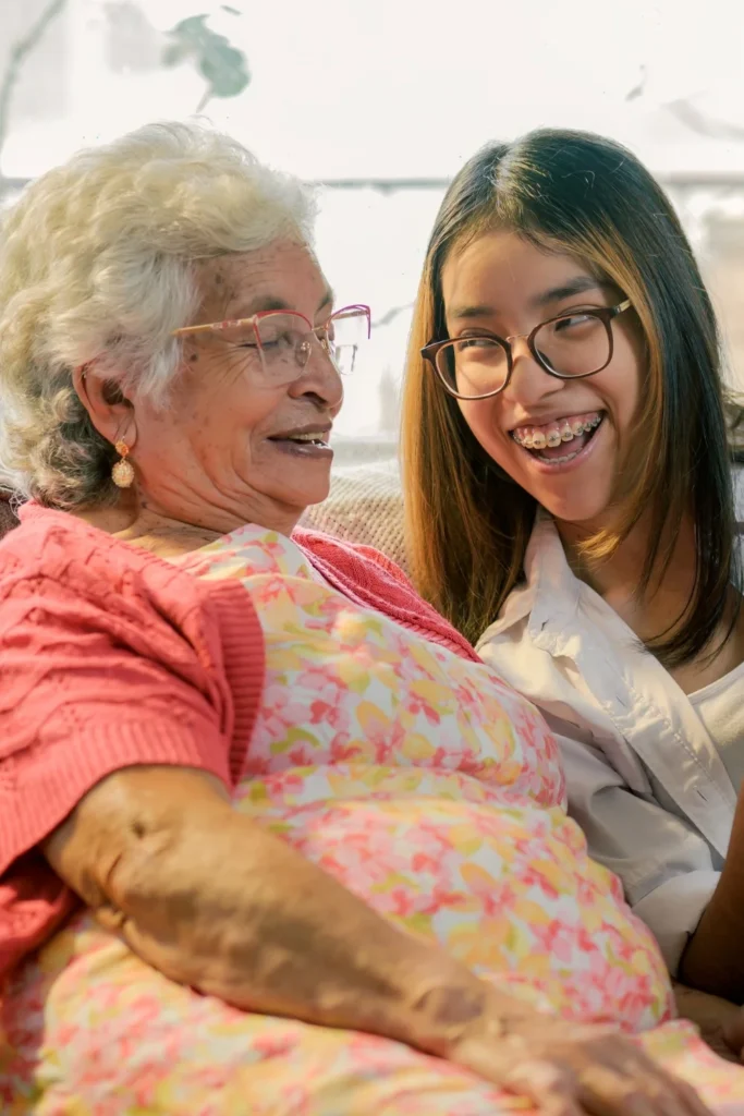 Grandmother and teenage granddaughter smiling together