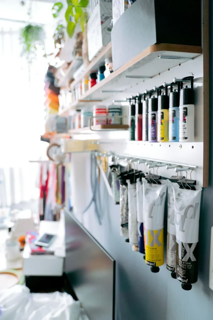 Craft supplies organized on wall-mounted shelves, hooks, and storage racks
