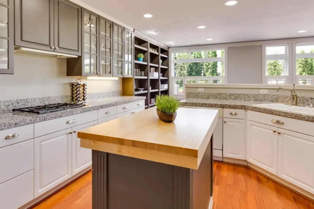 Kitchen with granite perimeter countertops and a large butcher-block island.