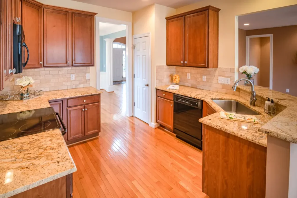 Kitchen with granite countertops surrounding the cooktop and sink.