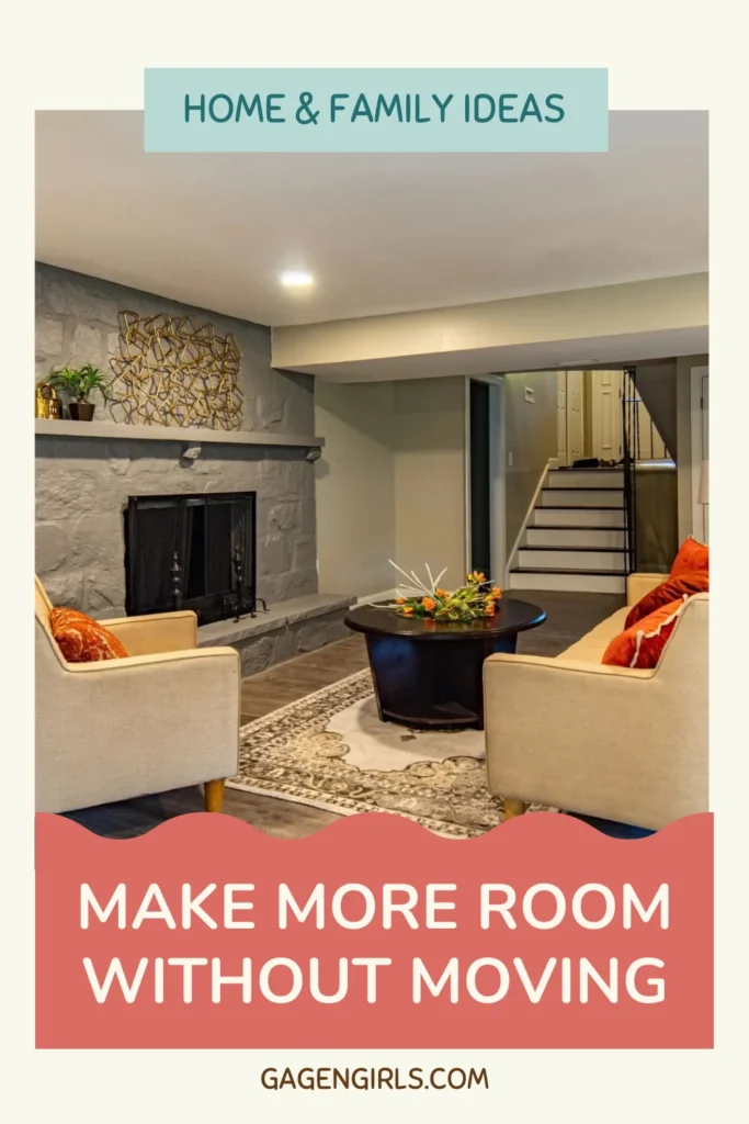 Pinterest graphic showing a cozy basement sitting area with a stone fireplace and cream-colored furniture, featuring the headline "Make More Room Without Moving."