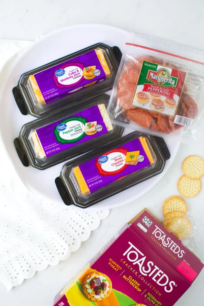 Crackers, sliced cheese, and pepperoni for making a Thanksgiving turkey snack tray
