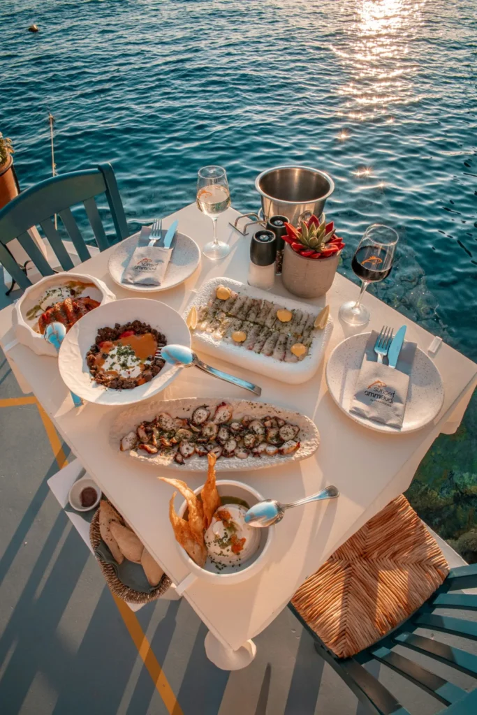 Romantic waterfront seafood dinner with a beautifully set table overlooking the water.
